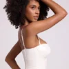 Top corto a corsetto con ferretti in vinile Cassandra, bianco Top corto a corsetto con ferretti in vinile Cassandra, bianco
