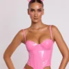 Top corto a corsetto con ferretti in vinile Cassandra, rosa Top corto a corsetto con ferretti in vinile Cassandra, rosa