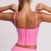Top corto a corsetto con ferretti in vinile Cassandra, rosa Top corto a corsetto con ferretti in vinile Cassandra, rosa