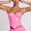 Top corto a corsetto con ferretti in vinile Cassandra, rosa Top corto a corsetto con ferretti in vinile Cassandra, rosa
