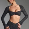 Top corto a maniche lunghe con decorazioni Lumina in nero Top corto a maniche lunghe con decorazioni Lumina in nero