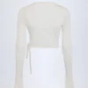 Top corto avvolgente Lou Pointelle in bianco Top corto avvolgente Lou Pointelle in bianco