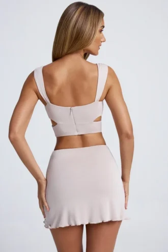 Top corto con cut-out e dettagli metallici Kira in grigio cielo