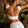 Top corto con maniche ad aletta e schiena scoperta Juno in bianco Top corto con maniche ad aletta e schiena scoperta Juno in bianco