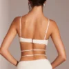 Top corto con spalline e ferretto decorato Parma in bianco Top corto con spalline e ferretto decorato Parma in bianco