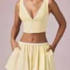 Top corto Magda con fiocco a righe giallo limone Top corto Magda con fiocco a righe giallo limone