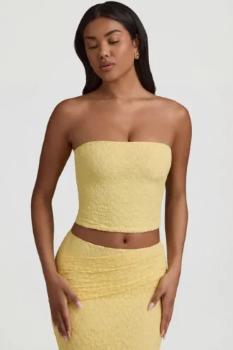 Top in pizzo senza spalline con arricciature Tamia in giallo pastello