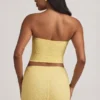 Top in pizzo senza spalline con arricciature Tamia in giallo pastello Top in pizzo senza spalline con arricciature Tamia in giallo pastello