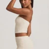 Top in pizzo senza spalline con ruches Tamia in avorio Top in pizzo senza spalline con ruches Tamia in avorio