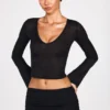 Top Liah in jersey trasparente con scollo profondo e maniche lunghe, colore nero Top Liah in jersey trasparente con scollo profondo e maniche lunghe, colore nero