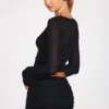 Top Liah in jersey trasparente con scollo profondo e maniche lunghe, colore nero Top Liah in jersey trasparente con scollo profondo e maniche lunghe, colore nero