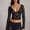 Top Lioren in pizzo trasparente con scollo profondo e maniche lunghe, colore nero Top Lioren in pizzo trasparente con scollo profondo e maniche lunghe, colore nero