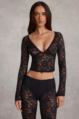 Top Lioren in pizzo trasparente con scollo profondo e maniche lunghe, colore nero