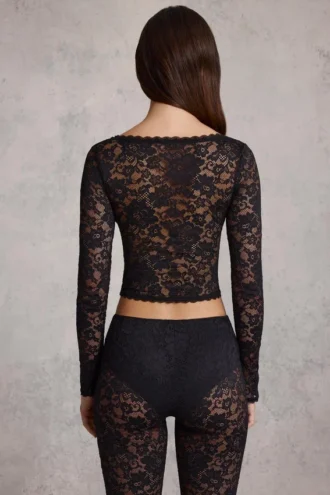 Top Lioren in pizzo trasparente con scollo profondo e maniche lunghe, colore nero