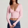 Top Lioren in pizzo trasparente con scollo profondo e maniche lunghe, colore rosa Top Lioren in pizzo trasparente con scollo profondo e maniche lunghe, colore rosa