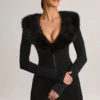 Tuta Corte con corsetto e bordi in pelliccia sintetica Nesta in nero Tuta Corte con corsetto e bordi in pelliccia sintetica Nesta in nero