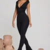 Tuta Intera Romana con scollo a V e vita arricciata in nero Tuta Intera Romana con scollo a V e vita arricciata in nero