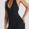 Tuta intera svasata con cut-out e bordi in pizzo Pema Modal in nero Tuta intera svasata con cut-out e bordi in pizzo Pema Modal in nero