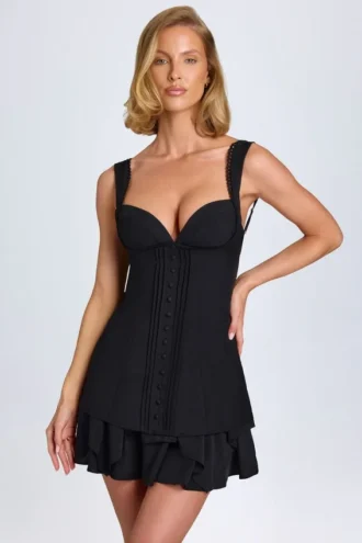 Vestito corto a corsetto con volant e bottoni Cassandra in nero