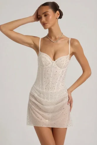Vestito corto a corsetto drappeggiato con decorazioni semi-trasparenti Connie in bianco