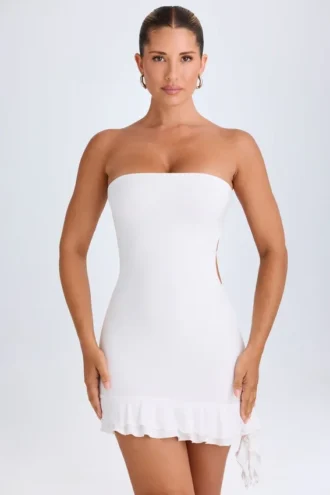 Vestito corto a fascia con cut-out e volant Misa in bianco