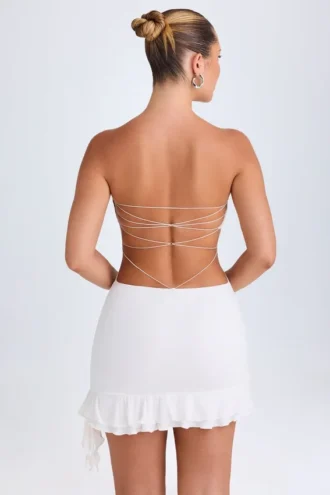 Vestito corto a fascia con cut-out e volant Misa in bianco
