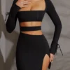 Vestito corto con maniche lunghe e cut-out Enya in nero Vestito corto con maniche lunghe e cut-out Enya in nero