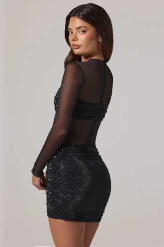 Vestito corto Noel trasparente con decorazioni, collo alto e maniche lunghe in nero