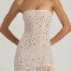 Vestito lungo asimmetrico semi-trasparente con decorazioni Kerra in bianco Vestito lungo asimmetrico semi-trasparente con decorazioni Kerra in bianco
