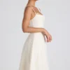 Vestito midi svasato plissettato con fiocco Isadora in avorio Vestito midi svasato plissettato con fiocco Isadora in avorio